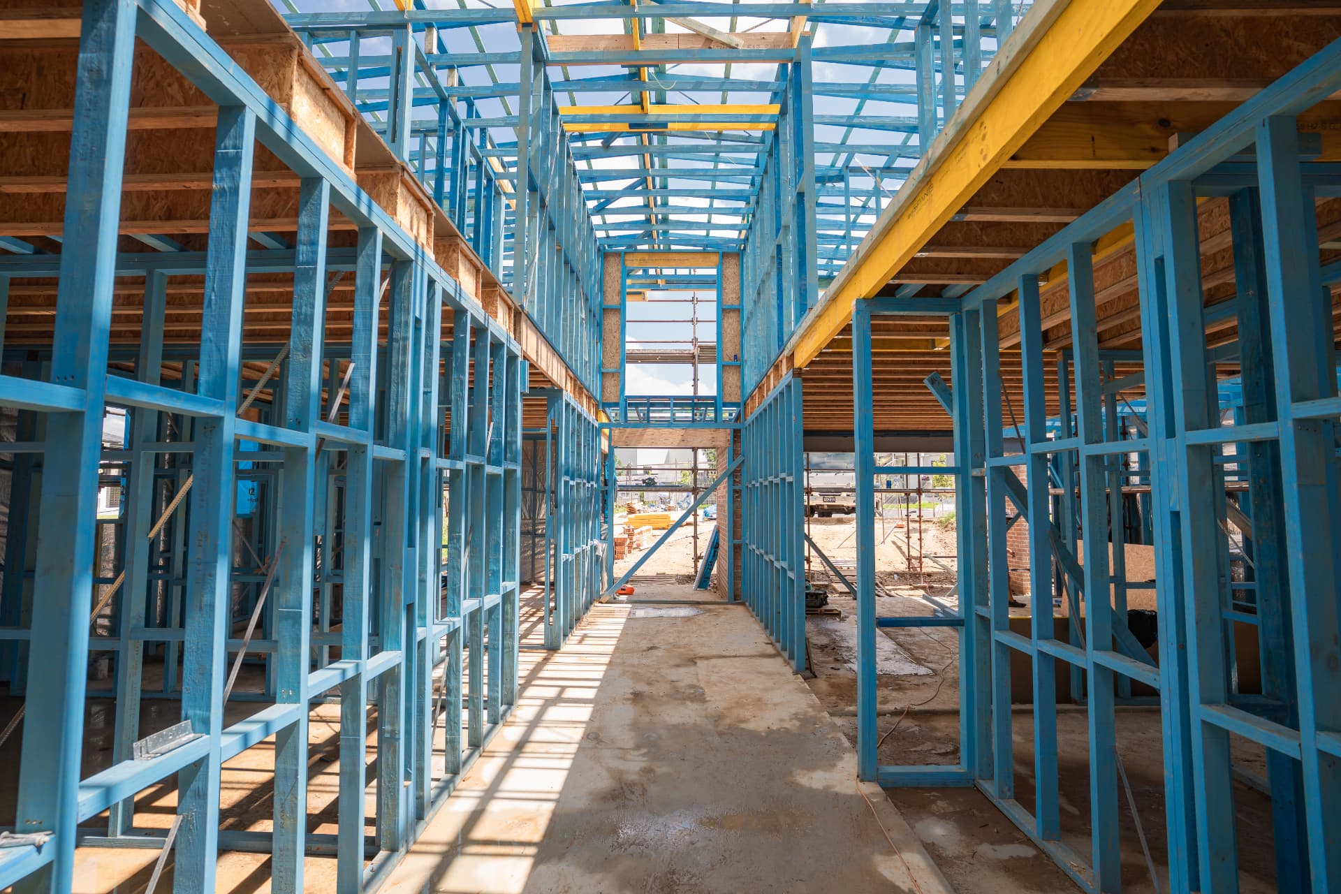 Hallway framed in structural timber with a yellow LVL beam spanning the opening