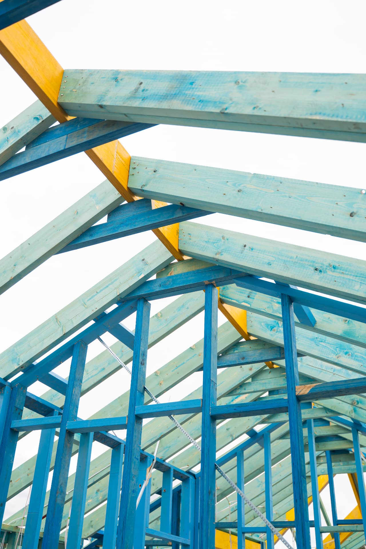 Detail of roof trusses and rafters against the sky on a timber-framed house