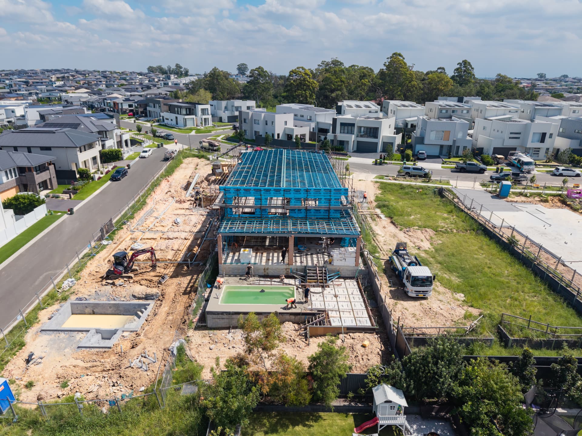 Aerial view of a Sydney residential build with the upper-floor timber frame and roof structure standing